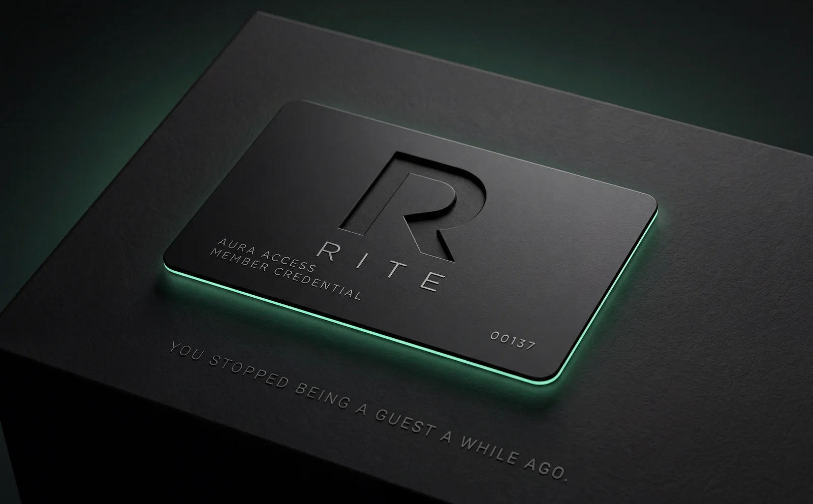 A matte black RITE member credential card, its edge glowing green, resting on a dark plinth